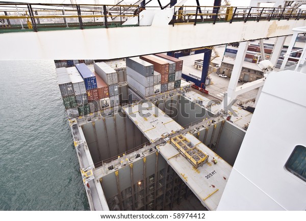 empty ship\'s cargo holds during container discharge\
in port