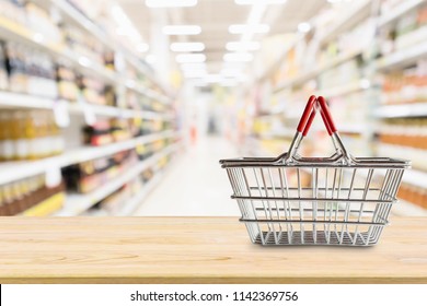 Empty Shopping Basket On Wood Table Over Grocery Store Supermarket Blur Background