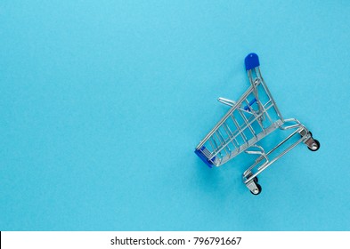 Empty Shopping Cart On Blue Background