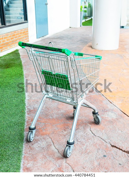 Empty shopping cart\
on the floor background