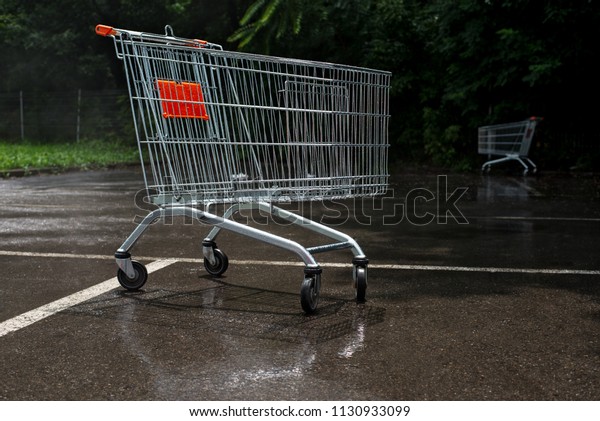 Empty\
shopping cart  at the supermarket parking\
lot.