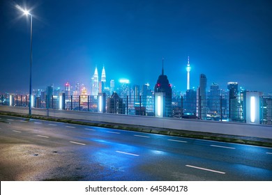 Empty side view asphalt with modern city skyline , night scene ,Kuala Lumpur , Malaysia . - Shutterstock ID 645840178