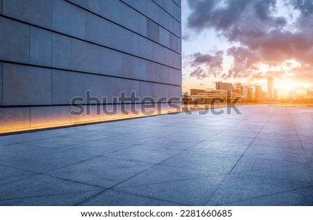 Empty sidewalk and city skyline at sunset