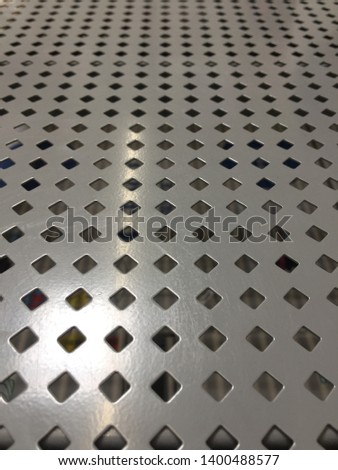 Empty silver store shelf with diamond holes