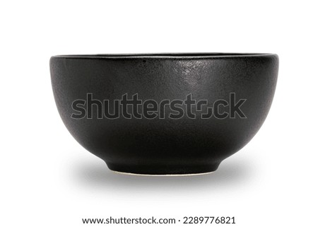 Empty single black ceramic bowl isolated on white background with clipping path, side view, closeup, horizontal format.