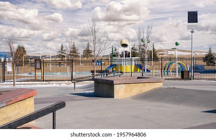 An Empty Skate Park And Outdoor Splash Park With Solar Panels Recharging LED Street Lights In The Urban Community Of Airdrie Alberta Canada.