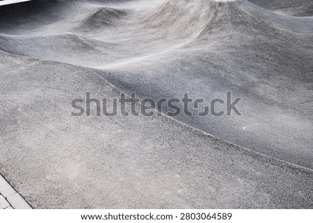 Empty skatepark concrete surface with smooth curved ramp texture, extreme sports and urban recreation infrastructure concept