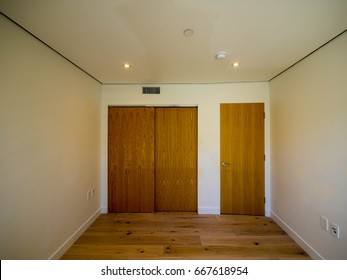 Empty Small Bedroom Modern Style Interior With Wood Floor Wood Built-in Closet Wood Door White Paint And Encase Lights