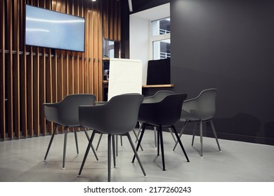 Empty Small Conference Room With Gray Office Chairs Against Plasma Screen And Whiteboard