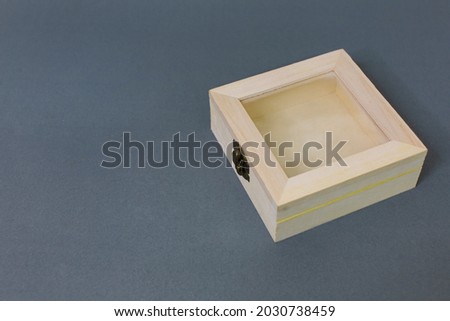 Empty small light brown wooden box Container objects are locked with separate latches on black background slots. 
