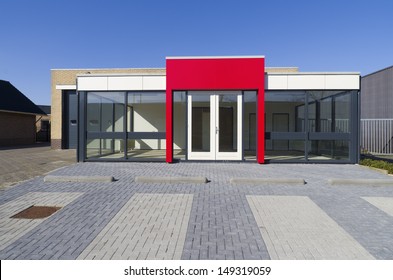 Empty Small Office Building With Red Entrance