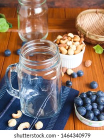 Empty Smoothie Cup With Blue Berries Around It