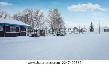 Empty snow-covered ground with beautiful winter small town