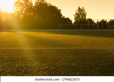 An Empty Soccer Field In The Sun. An Empty Playground At Sunset.