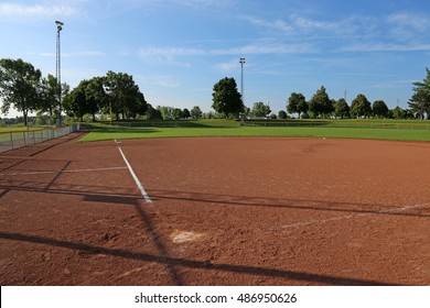 An Empty Softball Field On A Sunny Day.
