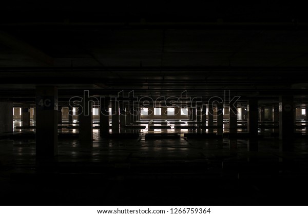 Empty space car park interior atnoon.Indoor\
parking lot.interior of parking garage with car and vacant parking\
lot in parking building.some carpark empty in Apartment or\
department store.