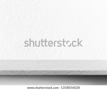 Empty space of concrete table floor for placing advertisement products with cement wall texture background.