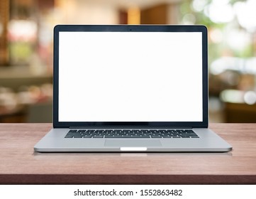 Empty space on wooden Desk with Laptop with blank white screen at coffee shop