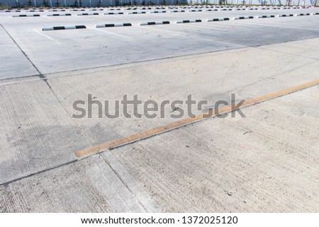 Empty space in the parking lot or the outdoor car park with black and white concrete barrier