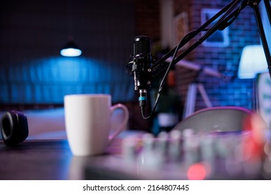 Empty space with podcast equipment to record talking show at home. No people in living room used for online vlogging and broadcasting conversation with microphone, sound production. - Shutterstock ID 2164807445