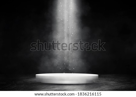 Empty space of Round white podium or pedestal in studio dark room black concrete floor grunge texture background with smoke and spotlight.