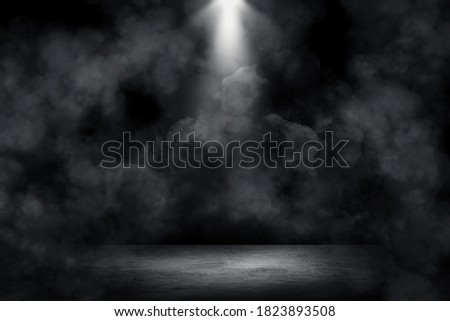 Empty space of Studio dark room concrete floor grunge texture background with spot lighting and fog or mist in background.