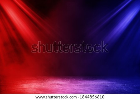 Empty space of Studio dark room with fog or mist and lighting effect red and blue on concrete floor grunge texture background.