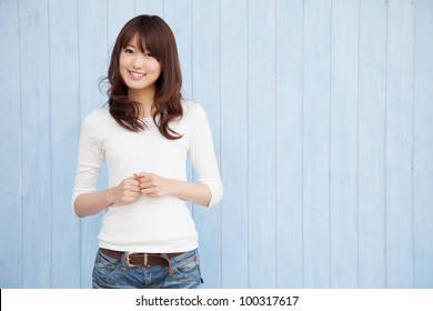 Empty space and a young Asian woman smiling blue background