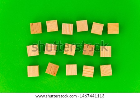 empty space for your text on wooden cubes on green background. any three words for an advertising slogan. the first word - six letters, the second - five letters, the third - five letters