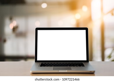 Empty space,desk white with on Laptop computer with blank screen and coffee cup ,at home office blurred background of light bokeh. - Shutterstock ID 1097221466