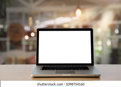 Empty space,desk white with on Laptop computer with blank screen and coffee cup ,at cafe blurred background of light bokeh. - Shutterstock ID 1098754160