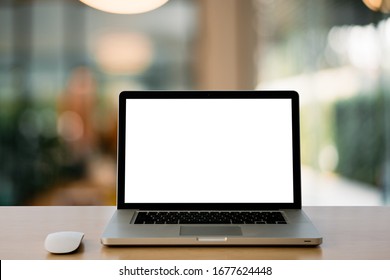 Empty Space,Wooden Computer Desk And Laptop With Blank Screen And Wireless Mouse In Office With Modern Blurred Background Light Bokeh.- Image