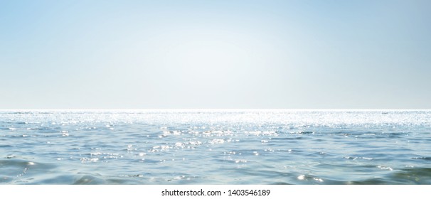 Empty Sparkling Sea, Abstract Ocean Background, Water Horizon View With Blue Sky And Sun Lights, Horizontal Waterscape Concept