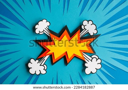 Empty speech bubble for your design. Handmade cut out paper craft art work on blue background. Pop art and comic style. 