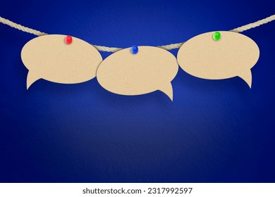 empty speech bubbles hanging on a thread on a blue background