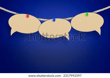 empty speech bubbles hanging on a thread on a blue background