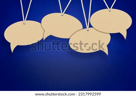 empty speech bubbles hanging on a thread on a blue background