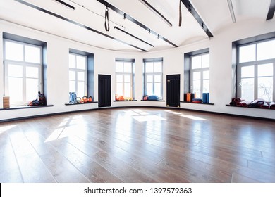 Empty Sports Gym With Large Windows And Sports Equipment In Anticipation Of Sports Activities. Yoga And Stretching Concept