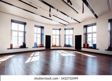 Empty Sports Gym With Large Windows And Sports Equipment In Anticipation Of Sports Activities. Yoga And Stretching Concept