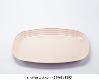 Empty square beige plastic plate, isolated on white background
