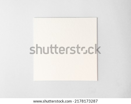 empty square cardboard sheet on a white table. empty space for text