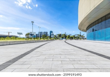 Empty square and cityscape with modern building under blue sky