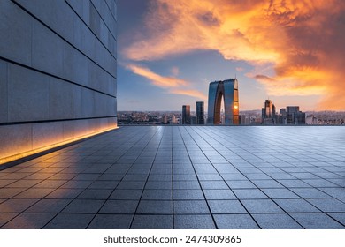 Empty square floor and brick wall with modern city buildings at sunset in Suzhou. high angle view.