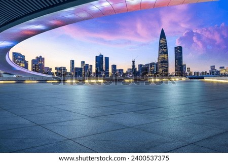 Empty square floor and bridge buildings with city skyline at dusk in Shenzhen, Guangdong Province, China.