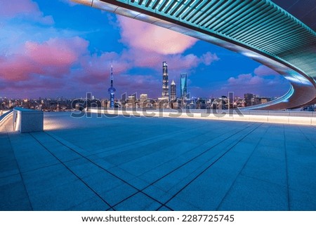 Empty square floor and bridge with city skyline at night in Shanghai, China.