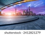 Empty square floor and bridge with modern city buildings at sunrise in Shanghai 