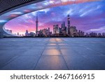 Empty square floor and bridge with modern city buildings scenery at night in Shanghai