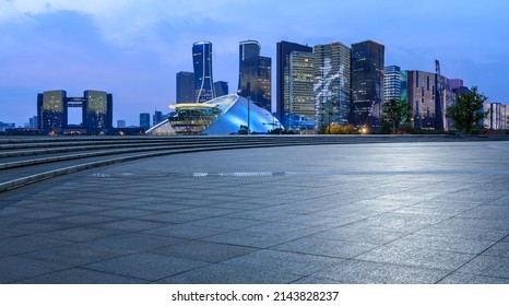 Empty Square Floor And City Skyline With Modern Commercial Buildings In Hangzhou At Night, China.