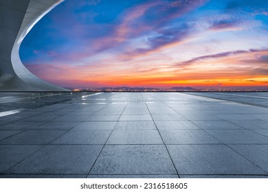 Empty square floor and city skyline with sky clouds at sunset - Powered by Shutterstock