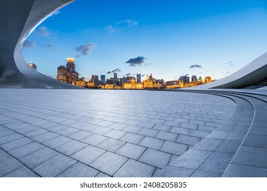 Empty square floor and city skyline with buildings at night in Shanghai  - Powered by Shutterstock